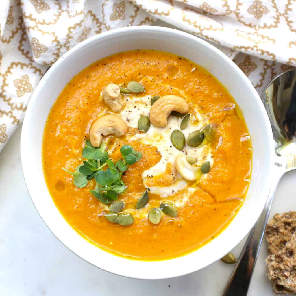 A delicious roasted carrot soup topped with cashew cream