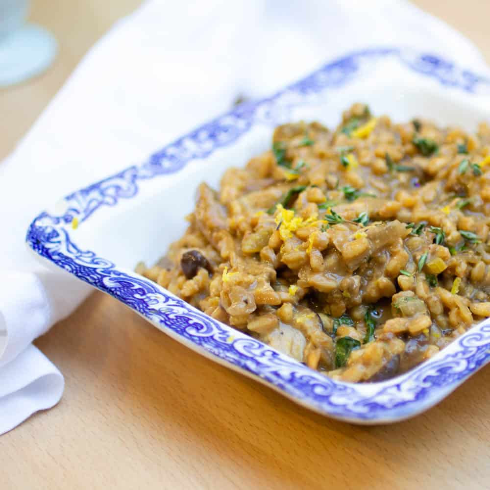 Vegan Mushroom Risotto in a white and blue serving platter
